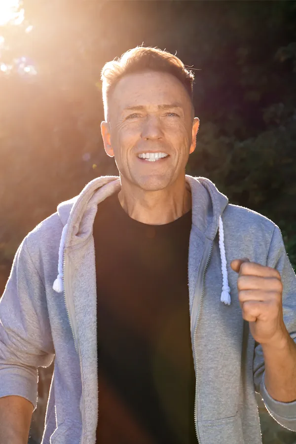 Bursitis-Treatment A smiling middle-aged man prepares for morning exercise. Get treatment for Bursitis from Pierre Rojas, DO in South Lyon.