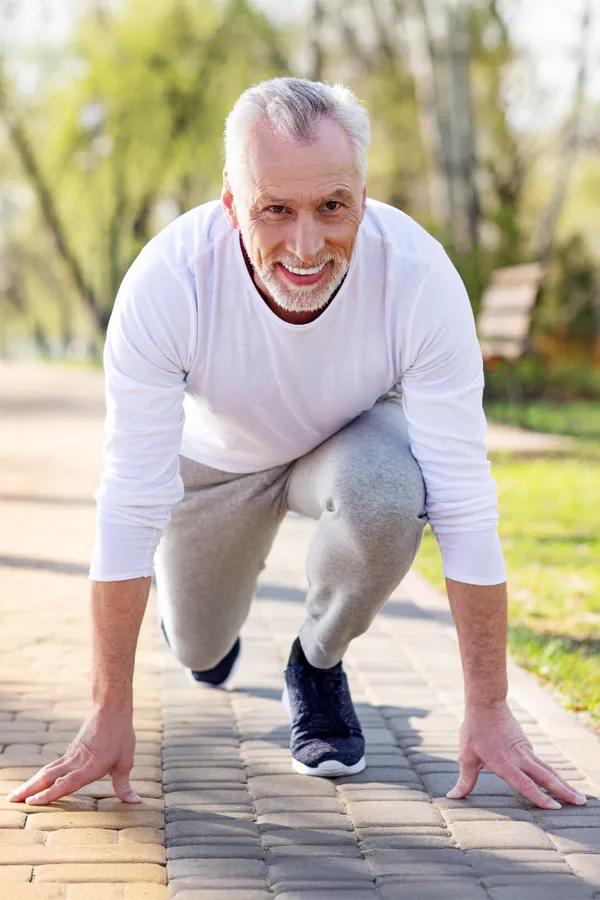 Degenerative-Disc-Disease-Treatment An older man sets in starting position for a run. Get treatment for degenerative disc disease from Pierre Rojas, DO in South Lyon.
