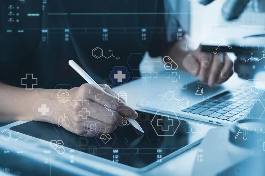 Health-Conditions-Treated-Doctor Close-up of a medical professional using a laptop and tablet, with illustrated medical symbols overlayed on the image, symbolizing health conditions treated by Pierre Rojas, DO in South Lyon.