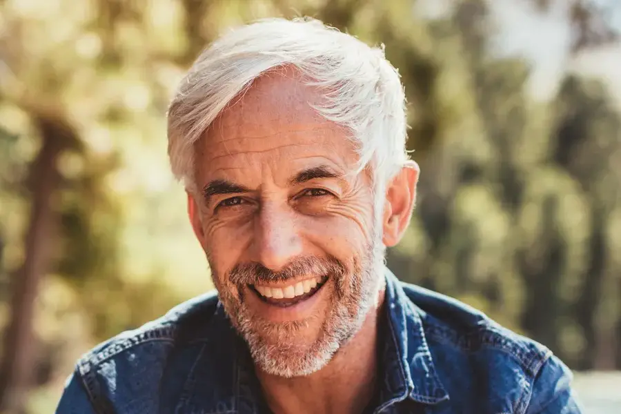 Mens-Health-Clinic A handsome mature man smiling in the forest. Make an appointment with men's health expert Pierre Rojas, DO in South Lyon today.