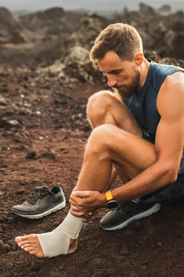 Carpal-Tunnel-Syndrome-Clinic A woman sits in front of her computer rubbing her hand in pain. Schedule treatment for carpal tunnel syndrome from Pierre Rojas, DO in South Lyon.