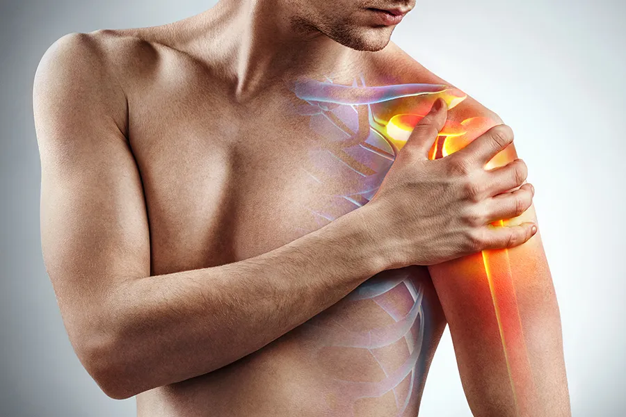 Rotator-Cuff-Clinic A man holds his shoulder; a 3D illustration of the musculo-skeletal shoulder is on the area. Get rotator cuff treatment from Pierre Rojas, DO in South Lyon.