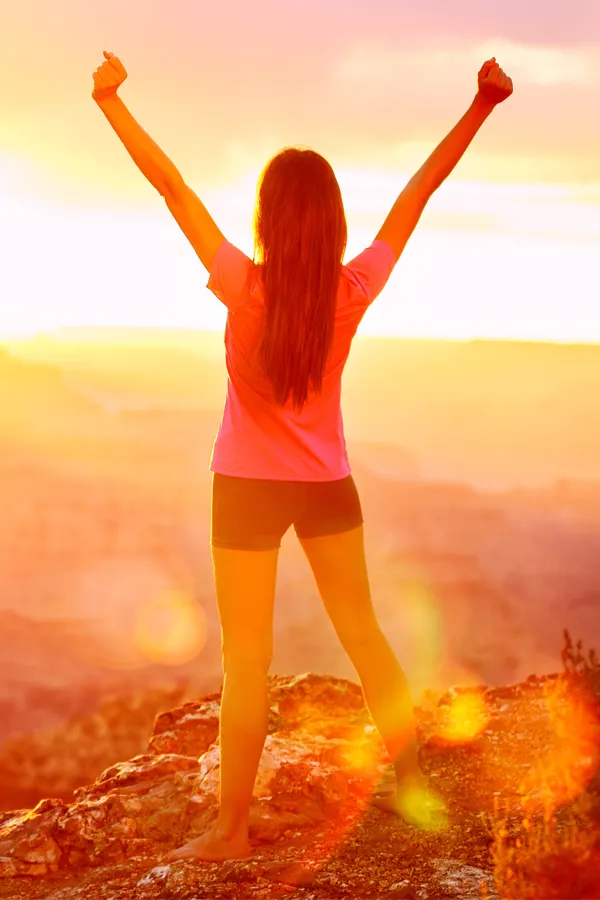 Rotator-Cuff-Treatment A woman raises her arms on a hilltop. Get rotator cuff treatment from Pierre Rojas, DO in South Lyon.