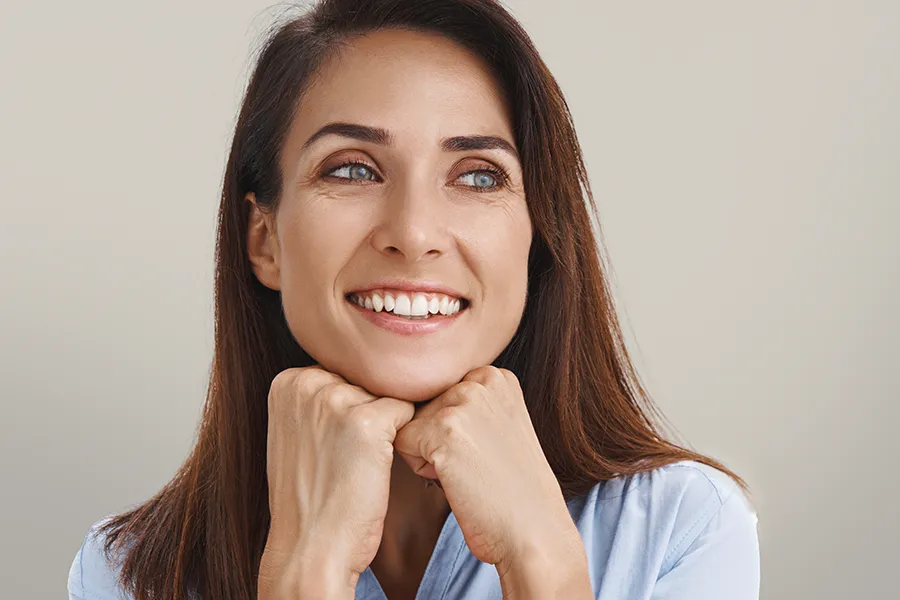 Xeomin-Facial-Injections-Clinic A woman with long brown hair and smooth radiant skin. Schedule Xeomin Facial Injections from Pierre Rojas, DO in South Lyon.